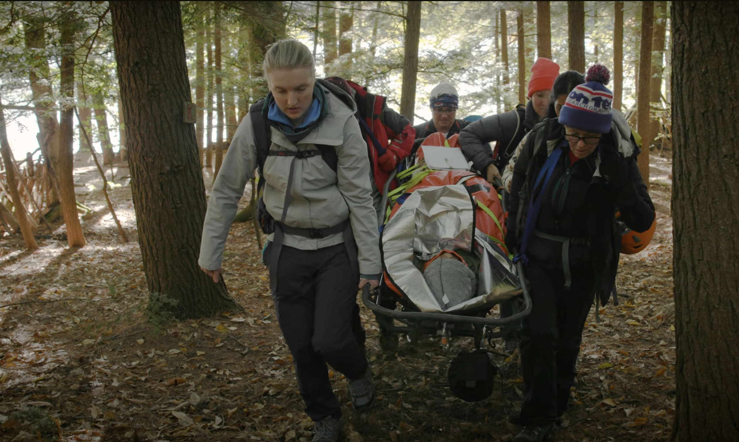 Extreme medicine students moving a casualty through woodland